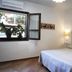 Turismo Rurale Belvedere Pradonos guest room in Dorgali with wrought-iron bed and open window