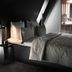 Boutique Hotel Hans Copenhagen bedroom with dark minimalist bed and sloped ceiling