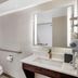 Quality Inn & Suites Union City - Atlanta South bathroom with vanity, mirror, toilet and grab bars