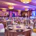 Four Points by Sheraton Milwaukee North Shore ballroom setup with round banquet tables and lit stage in Brown Deer