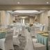 Four Points by Sheraton Milwaukee North Shore in Brown Deer banquet room with round tables and floral centerpieces