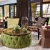 Omni Rancho Las Palmas Resort & Spa lobby seating area with tufted ottoman and patio doors in Rancho Mirage