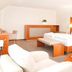 Ringhotel Teutoburger Wald in Brochterbeck: bright guest room with double bed, armchair, and desk