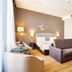 Eurostars Patios de Cordoba room in Córdoba with sofa, bed, wood floors and wardrobe