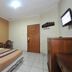 Hotel Mataram Malioboro Yogyakarta room with double bed, tiled floor, wooden desk and wall-mounted TV