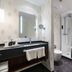 Schlosshotel Weyberhöfe bathroom in Sailauf with glass shower, vanity sink, and separate toilet