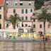 Hotel Splendid Mare in Laigueglia with beachfront loungers, palm trees, and seaside buildings