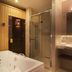 City Residence Apartment Hotel in Košice bathroom with bathtub, glass shower, and wall-mounted vanity