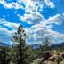 The Historic Crags Lodge in Estes Park with mountain and pine forest views under a blue sky