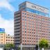 Route Inn Grantia Hakodate Ekimae hotel exterior in Hakodate, a tall pink-and-gray building