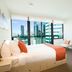 City Tempo Melbourne room with large city-view windows and contemporary seating