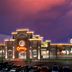 Cannery Casino Hotel in North Las Vegas at dusk with neon-lit facade and parking lot