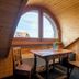 Hotel Sonne - Self Check-in in Schwarzenburg attic seating nook with arched window and wooden table