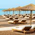 Titanic Deluxe Lara, Antalya: beachfront with sun loungers and straw parasols on sandy shore