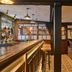 The White Horse, Dorking: cozy hotel bar with wooden counter, stools and warm traditional lounge seating
