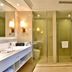 Zhong'an Huana Holiday Hotel bathroom in Hangzhou with walk-in shower, soaking tub, and double vanity