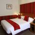 The Railway Inn in Brixham room with double bed, red striped headboard and bedside lamps