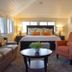 Mccall House Boutique Inn in Ashland guest room with king bed, sofa, armchair, and table