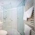 Gasthof zum Löwen in Weißenhorn bathroom with glass shower, large mirror and towel warmer