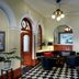First Hotel City Eskilstuna lobby with black-and-white tile floor, seating area, and arched doorway