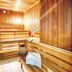 Leonardo Hotel & Residenz München sauna with wooden benches and bucket in Munich