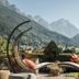 Biohotel Rastbichlhof in Neustift im Stubaital with mountain-view terrace loungers and hanging chairs