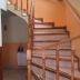 Hosteria Ailen in Ushuaia stairway with wooden handrails and tiled steps inside the hotel
