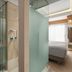 Mediterranean Hotel in Rhodes bathroom with glass shower and a glimpse of the bedroom