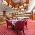 Iris Orchard All Suites Hotel (Tangshan Convention Center) dining area in Tangshan with red chairs and striped carpet