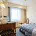 New Royal Hotel Shimanto guest room in Shimanto with single bed, desk, and large window