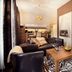 City Residence Apartment Hotel Košice suite with sofa, coffee table, zebra rug, and kitchenette seating area