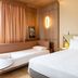 Novotel Toulouse Purpan Aéroport room with one bed, sofa bed and wood-paneled walls in Toulouse