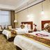 Jinhou Group Weihai Hotel in Weihai guest room with two twin beds and seating area