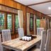 Jambuluwuk Convention Hall & Resort Batu dining room with long table, wooden walls and large windows