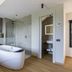 Antico Borgo di Sutri bathroom with freestanding tub, walk-in shower and wood flooring in Sutri