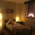 Hotel Alt Annaberg guest room with single bed, lit lamp, and curtained window in Annaberg-Buchholz