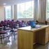 SJ Tour - San Juan Foz do Iguaçu meeting room with rows of chairs, desks and laptop by large windows