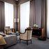 Althoff Grandhotel Schloss Bensberg room in Bergisch Gladbach with tall windows, chairs, and a bed