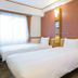 Toyoko Inn Tobu Utsunomiya eki Nishi guchi room with two twin beds and window in Utsunomiya