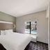 Quality Inn & Suites Irving Dfw Airport South room with king bed and pool view in Irving