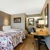 Red Roof Inn Asheville - Biltmore West room with two beds, desk and lamps in Asheville