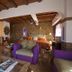 Villa Bella Bed & Breakfast Inn in La Cruz de Huanacaxtle: rustic guest room with purple chairs and wood ceiling
