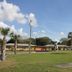 Prince of Wales Motel in Lake Wales with single-story motel rooms, palm trees and a grassy lawn