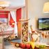 Hotel Lärchenhof room with canopy bed, fireplace, TV and mountain-view decor in Rennweg am Katschberg