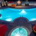 Cannery Casino Hotel in North Las Vegas pool deck with glowing lagoon pool and red umbrellas