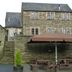 The Manor House Hotel in Dronfield, stone hotel exterior with stairs and outdoor picnic tables