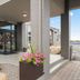 Country Inn & Suites by Radisson Coon Rapids, MN entrance with flower planter and covered walkway