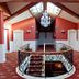 Hotel Fraga do Eume in Capela: elegant stair landing with chandelier, skylights, and red carpeted hallway