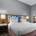 Hampton Inn & Suites Birmingham-Pelham guest room with king bed, desk, and full-length mirror in Pelham
