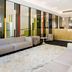 City Tempo Melbourne lobby with gray sofas, reception desk and modern lounge seating